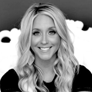 Chelsea Swift, a blonde white woman with shoulder length hair, wearing a black shirt.