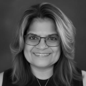 AnaRosa Muñoz, a Latina woman with shoulder length hair and wearing glasses.